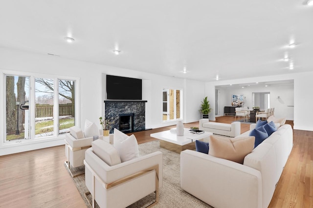 living room featuring light hardwood / wood-style flooring and a high end fireplace