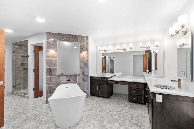 bathroom featuring tile flooring, tile walls, vanity with extensive cabinet space, double sink, and plus walk in shower