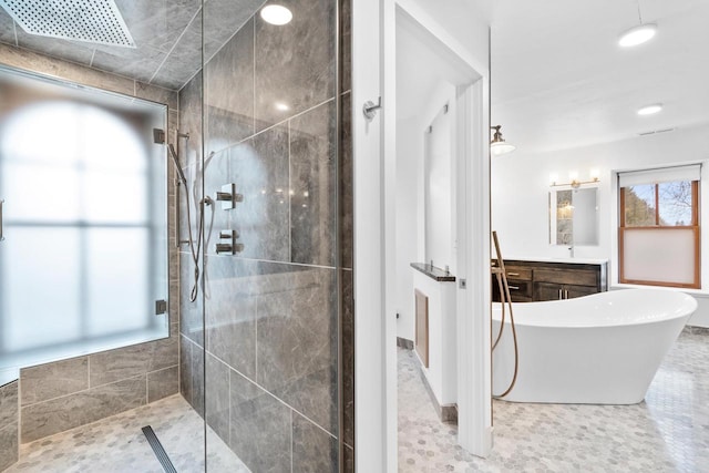 bathroom featuring shower with separate bathtub, vanity, and tile flooring