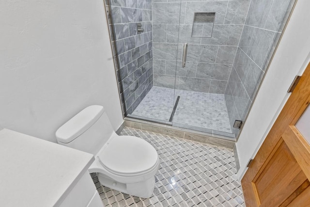 bathroom featuring tile flooring, toilet, and a shower with shower door