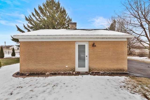 view of snow covered back of property