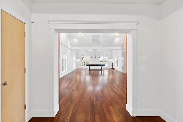 corridor featuring vaulted ceiling and hardwood / wood-style flooring