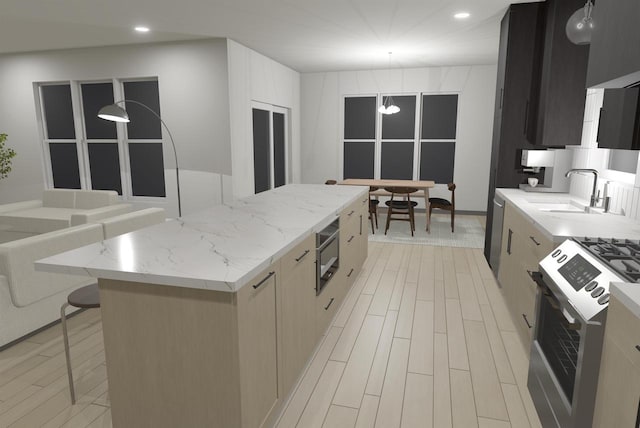 kitchen featuring a breakfast bar, light hardwood / wood-style floors, a kitchen island, gas range oven, and hanging light fixtures