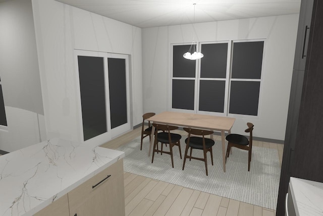 dining space featuring a notable chandelier and light hardwood / wood-style flooring