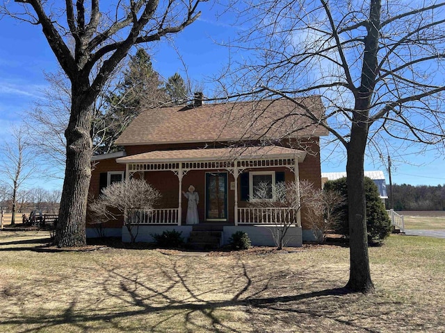3367 County Road Y, Custer, WI 54423 - view of front of house with a porch, a chimney, and a shingled roof