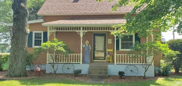 3367 County Road Y, Custer, WI 54423 - doorway to property featuring a shingled roof and covered porch