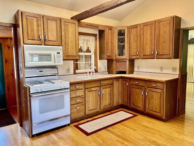 3367 County Road Y, Custer, WI 54423 - kitchen with white appliances, a sink, brown cabinetry, light wood-style flooring, and vaulted ceiling