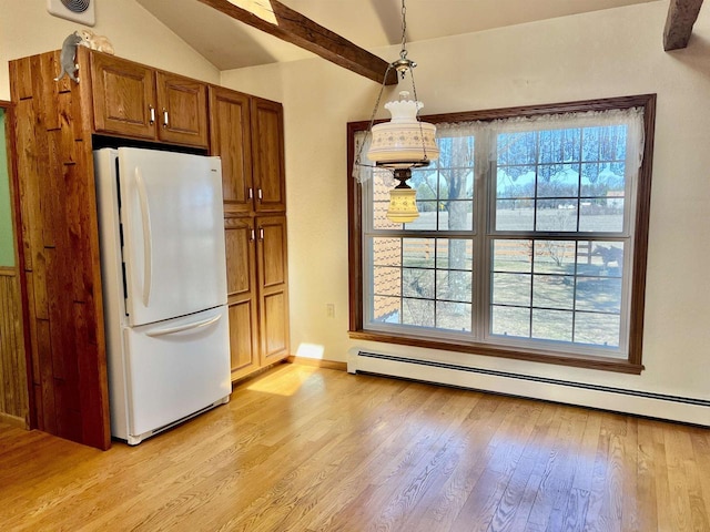 3367 County Road Y, Custer, WI 54423 - kitchen with freestanding refrigerator, light wood-style flooring, vaulted ceiling, brown cabinets, and plenty of natural light