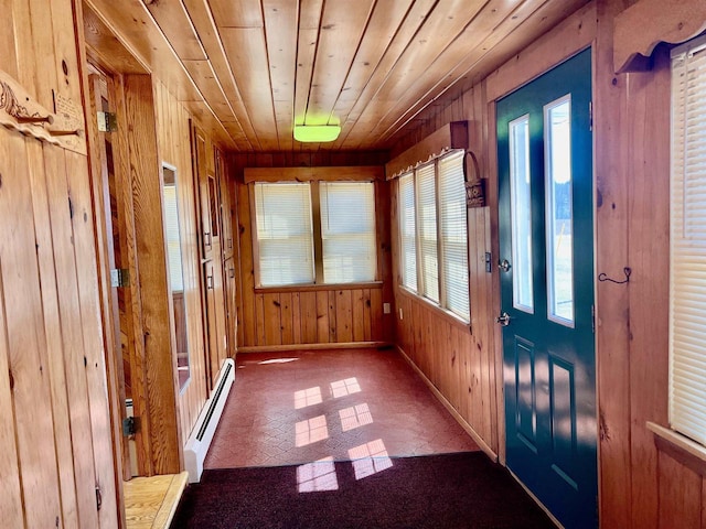 3367 County Road Y, Custer, WI 54423 - foyer featuring a baseboard heating unit, wooden walls, baseboards, wood ceiling, and brick patterned flooring