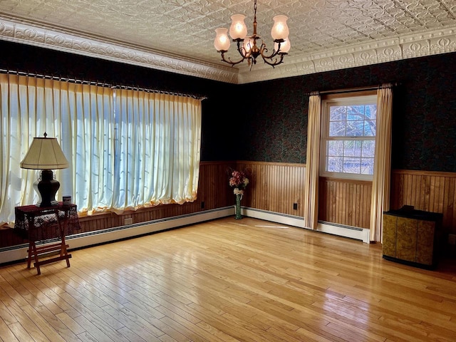 3367 County Road Y, Custer, WI 54423 - unfurnished dining area featuring a wainscoted wall, an ornate ceiling, a chandelier, and hardwood / wood-style flooring