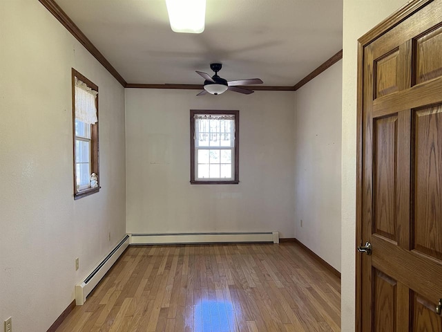 3367 County Road Y, Custer, WI 54423 - empty room with a baseboard heating unit, crown molding, light wood-type flooring, baseboards, and ceiling fan
