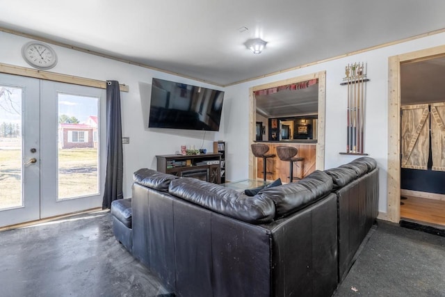 living room featuring french doors and a healthy amount of sunlight