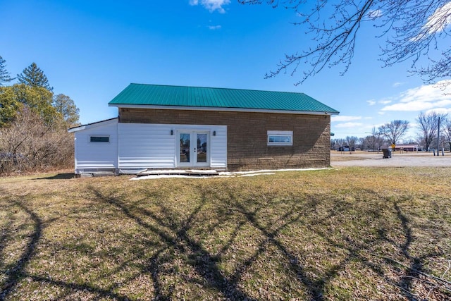 back of house featuring french doors and a yard