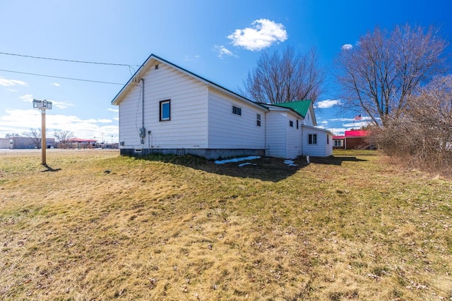 view of home's exterior with a yard