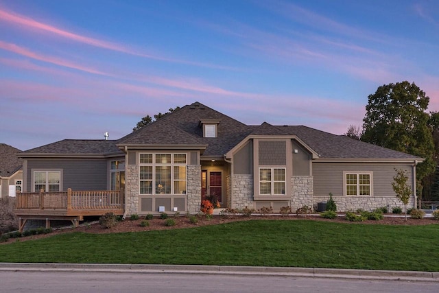 view of front of house with a lawn and a deck