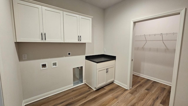 laundry room featuring cabinets, washer hookup, electric dryer hookup, and wood-type flooring