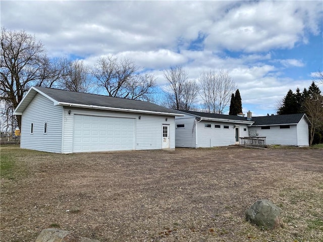 view of front of home featuring a garage and an outdoor structure