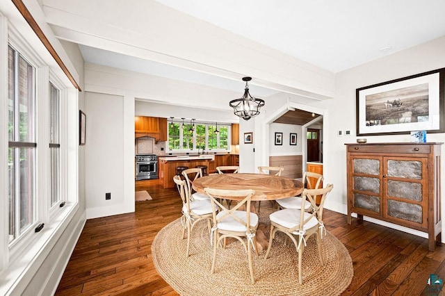 dining space with an inviting chandelier and dark hardwood / wood-style flooring