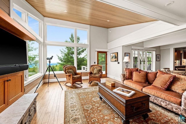 living room with a high ceiling, french doors, wooden ceiling, and light wood-type flooring