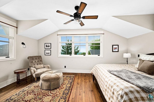 bedroom with ceiling fan, dark wood-type flooring, and vaulted ceiling