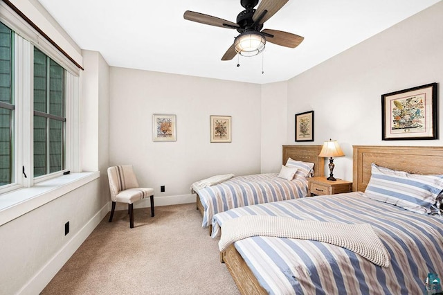 bedroom with light carpet and ceiling fan