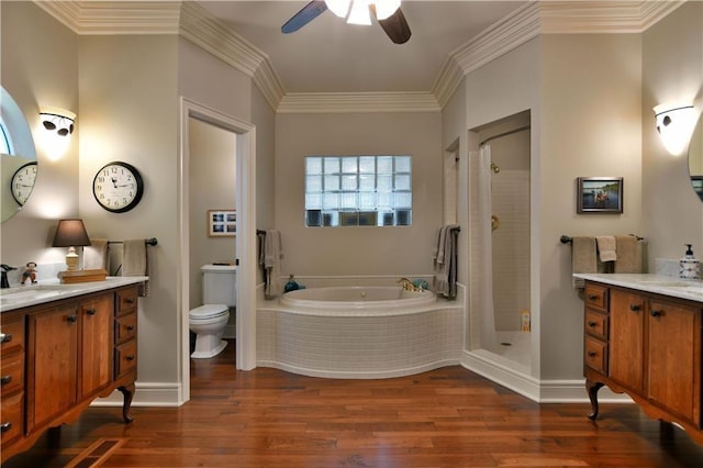 full bathroom with plus walk in shower, toilet, vanity, hardwood / wood-style floors, and ceiling fan