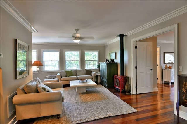 living room with ceiling fan, ornamental molding, dark hardwood / wood-style floors, and a wood stove