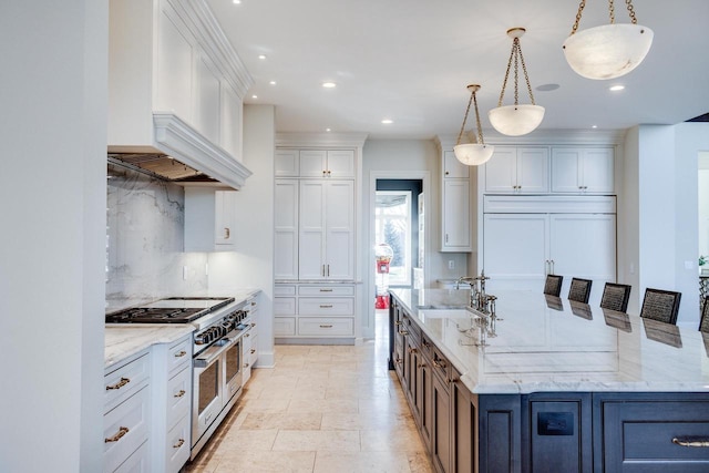 9809 Trappers Trl, Middleton, WI 53562 - kitchen featuring white cabinetry, pendant lighting, high end appliances, and light stone countertops
