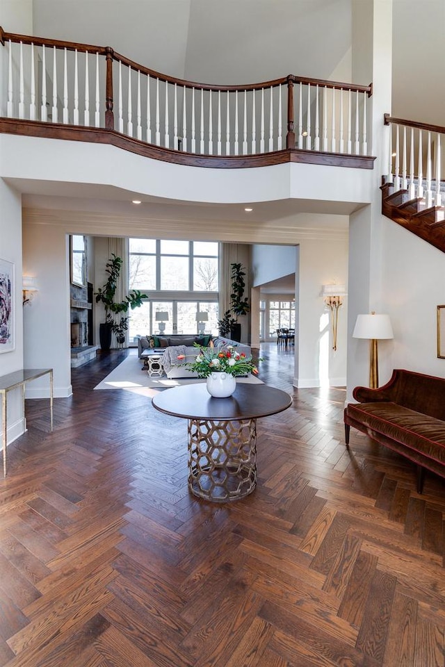 9809 Trappers Trl, Middleton, WI 53562 - living room with dark parquet flooring, a high ceiling, and a stone fireplace