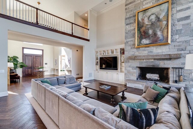 9809 Trappers Trl, Middleton, WI 53562 - living room featuring dark parquet floors, ornamental molding, a high ceiling, and a stone fireplace
