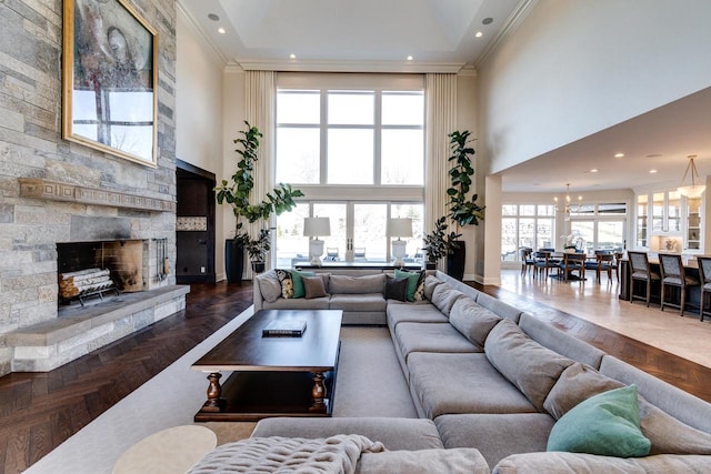 9809 Trappers Trl, Middleton, WI 53562 - living room with a towering ceiling, dark parquet floors, a healthy amount of sunlight, and a stone fireplace