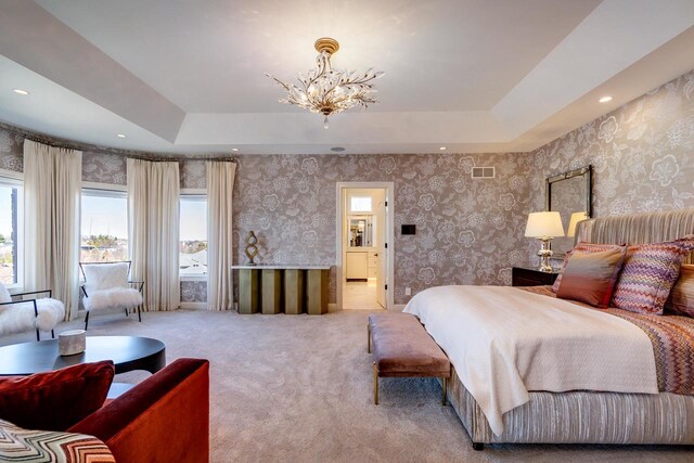 9809 Trappers Trl, Middleton, WI 53562 - carpeted bedroom with a chandelier, a raised ceiling, and ensuite bathroom