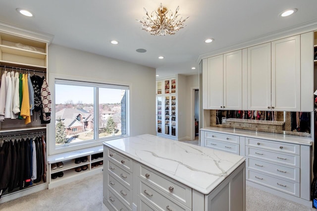 9809 Trappers Trl, Middleton, WI 53562 - kitchen with white cabinets, light stone counters, light carpet, and tasteful backsplash
