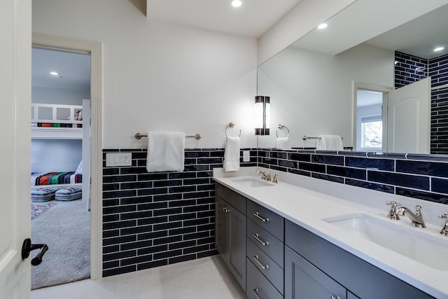 9809 Trappers Trl, Middleton, WI 53562 - bathroom with dual sinks, oversized vanity, tasteful backsplash, tile flooring, and tile walls
