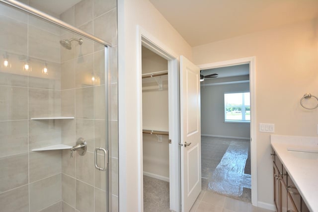 bathroom with a shower with shower door and vanity