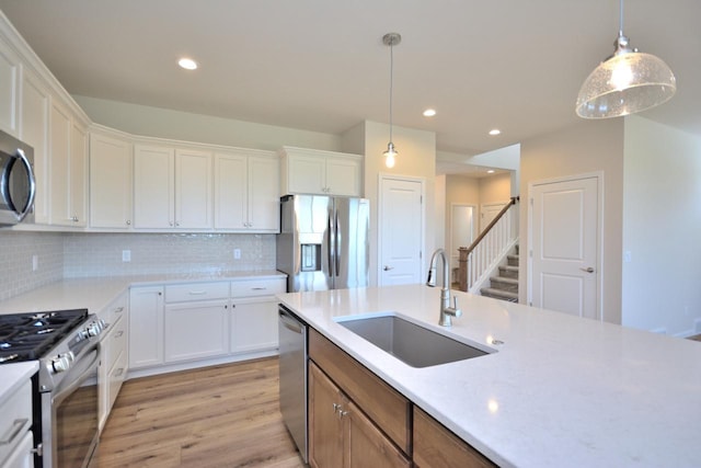 kitchen with white cabinets, sink, and stainless steel appliances