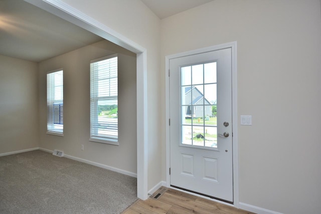 entryway featuring a healthy amount of sunlight and light hardwood / wood-style floors