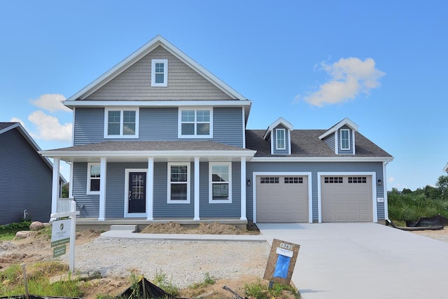 view of front of home with a porch and a garage