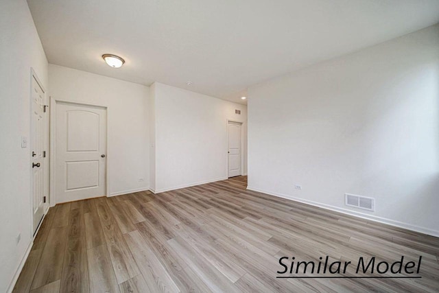 unfurnished room with light wood-type flooring