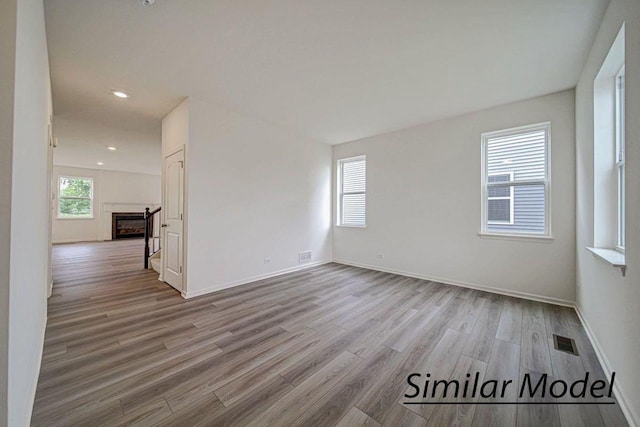 unfurnished room with light hardwood / wood-style floors