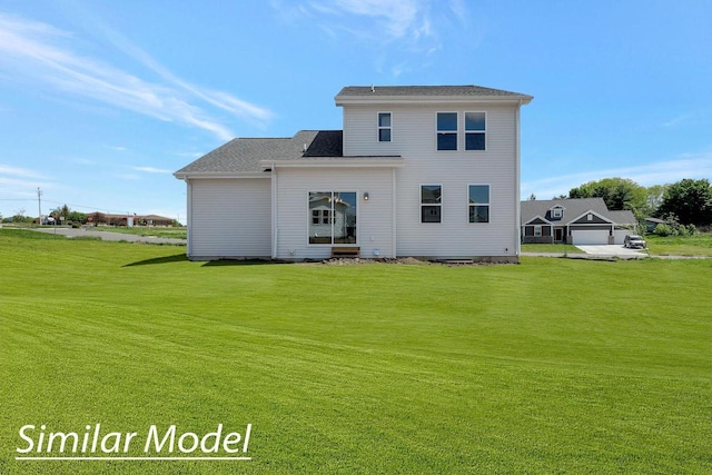 back of house with a garage and a lawn