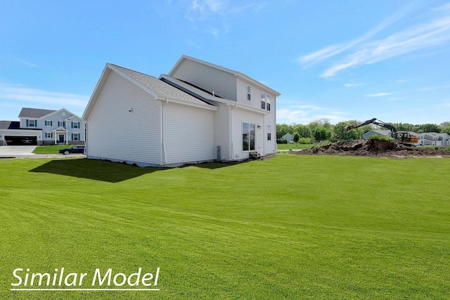 back of house with a lawn