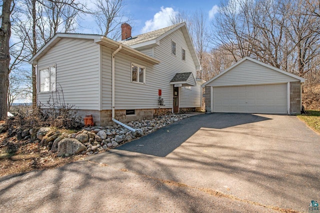 view of property exterior featuring a garage and an outdoor structure