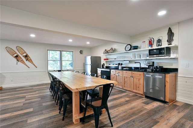 kitchen featuring appliances with stainless steel finishes, dark hardwood / wood-style floors, and sink