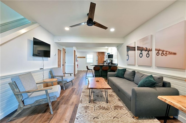 living room featuring hardwood / wood-style floors and ceiling fan