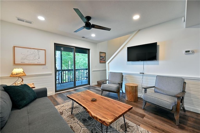 living room with ceiling fan and dark hardwood / wood-style flooring