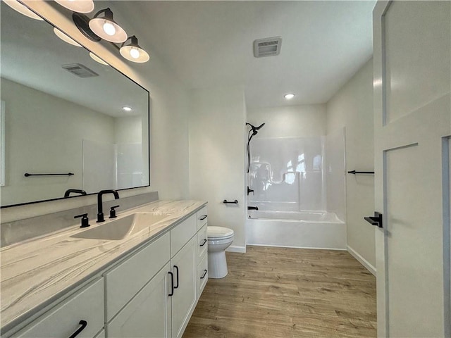 full bathroom featuring bathing tub / shower combination, vanity, toilet, and wood-type flooring