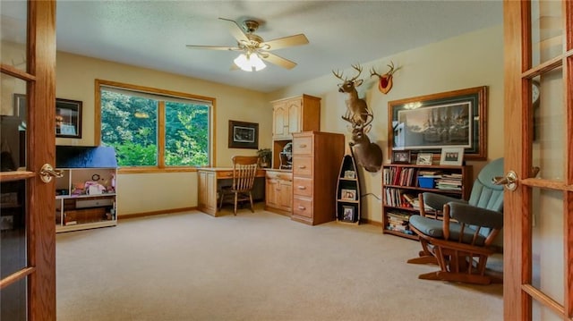 interior space with light colored carpet and ceiling fan