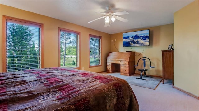 carpeted bedroom with ceiling fan and multiple windows