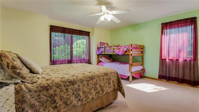 bedroom featuring light colored carpet and ceiling fan